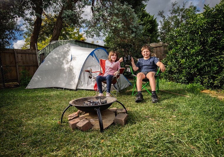 10.04.20 The Age 
Booking: 188792
Box Hill
Photo shows Archie Smith, 11 and his sister Dana, 8 who have been spending their holidays at home setting up fire pits, drinking tea and doing whittling in their backyard.
Photo: Scott McNaughton / The Age