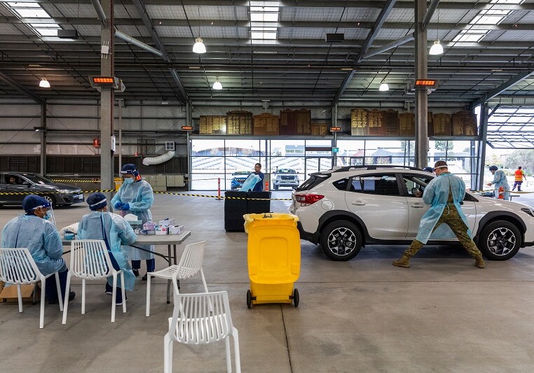 MELBOURNE, AUSTRALIA - JULY 04: People get tested by Australian Defense Force (ADF) personnel for Covid-19 at a drive through testing site at Flemington which sits on the border of a hotspot suburb on July 04, 2020 in Melbourne, Australia. Lockdowns across Melbourne are in effect for residents of suburbs identified as COVID-19 hotspots following a spike in new coronavirus cases through community transmission. Residents of the 10 Melbourne hotspot postcodes are only able to leave home have for exercise or work, to buy essential items including food or to access childcare and healthcare. Businesses and facilities in these lockdown areas are also restricted and cafes and restaurants can only open for takeaway and delivery. The restrictions will remain in place until at least 29 July.  (Photo by Asanka Ratnayake/Getty Images)
